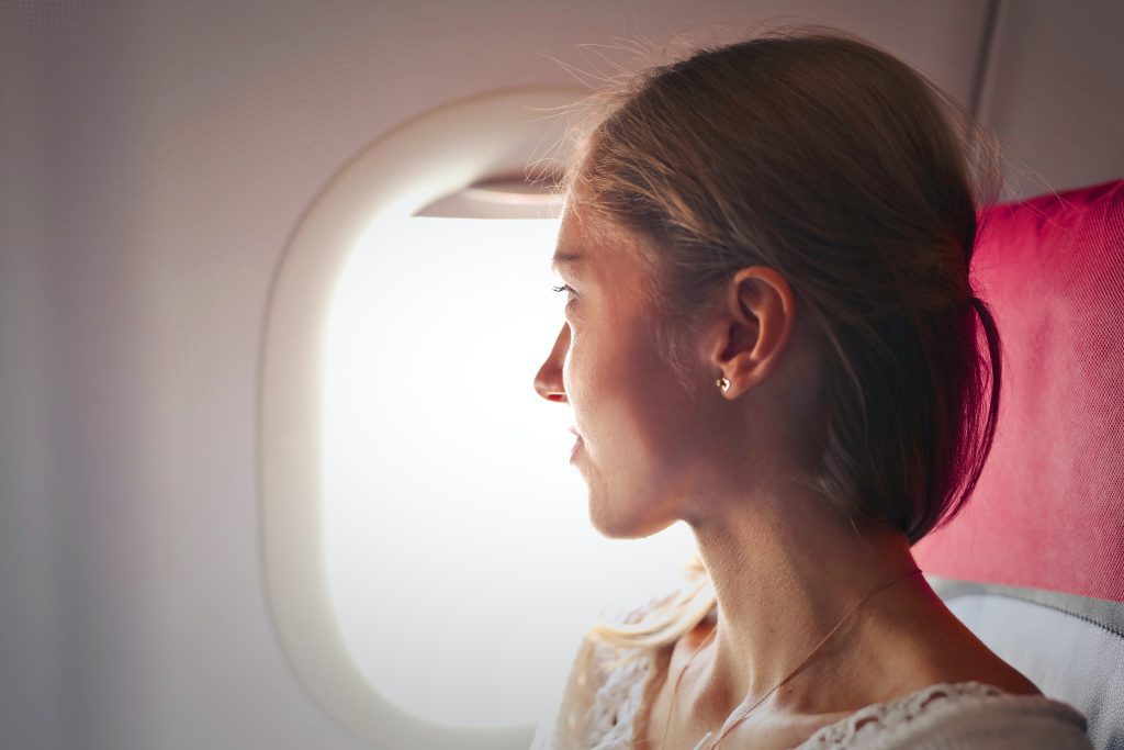 Woman looking out of airplane window