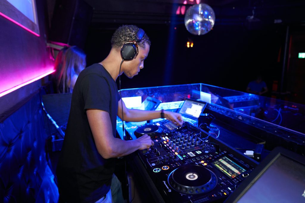 A nightclub DJ playing music