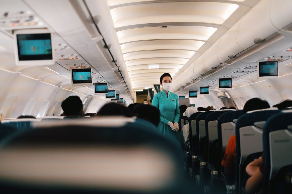 Flight attendant serving passengers