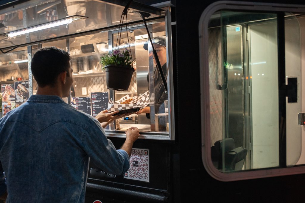 A man buys food from a food truck