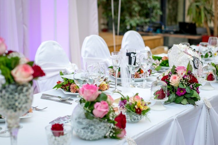 A wedding table setting with dining places and flowers